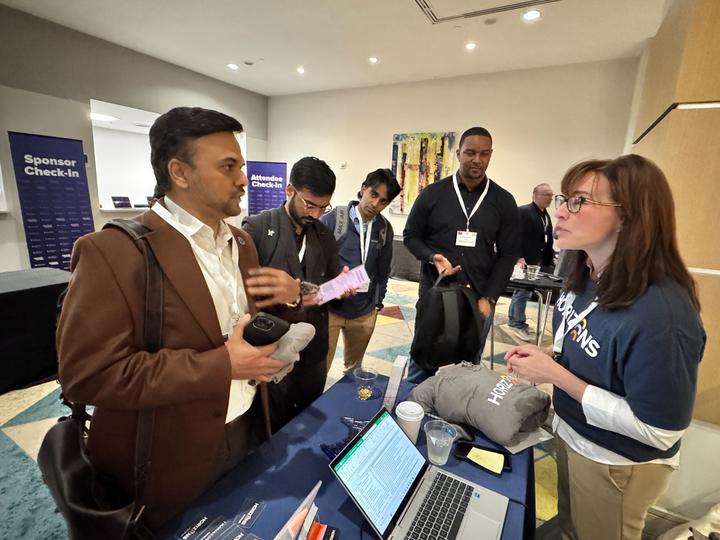 Emerging Tech Summit attendees engaging with the Horizons Innovation Lab booth.