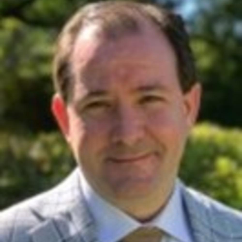 Headshot of Clark Rainer in suit and tie