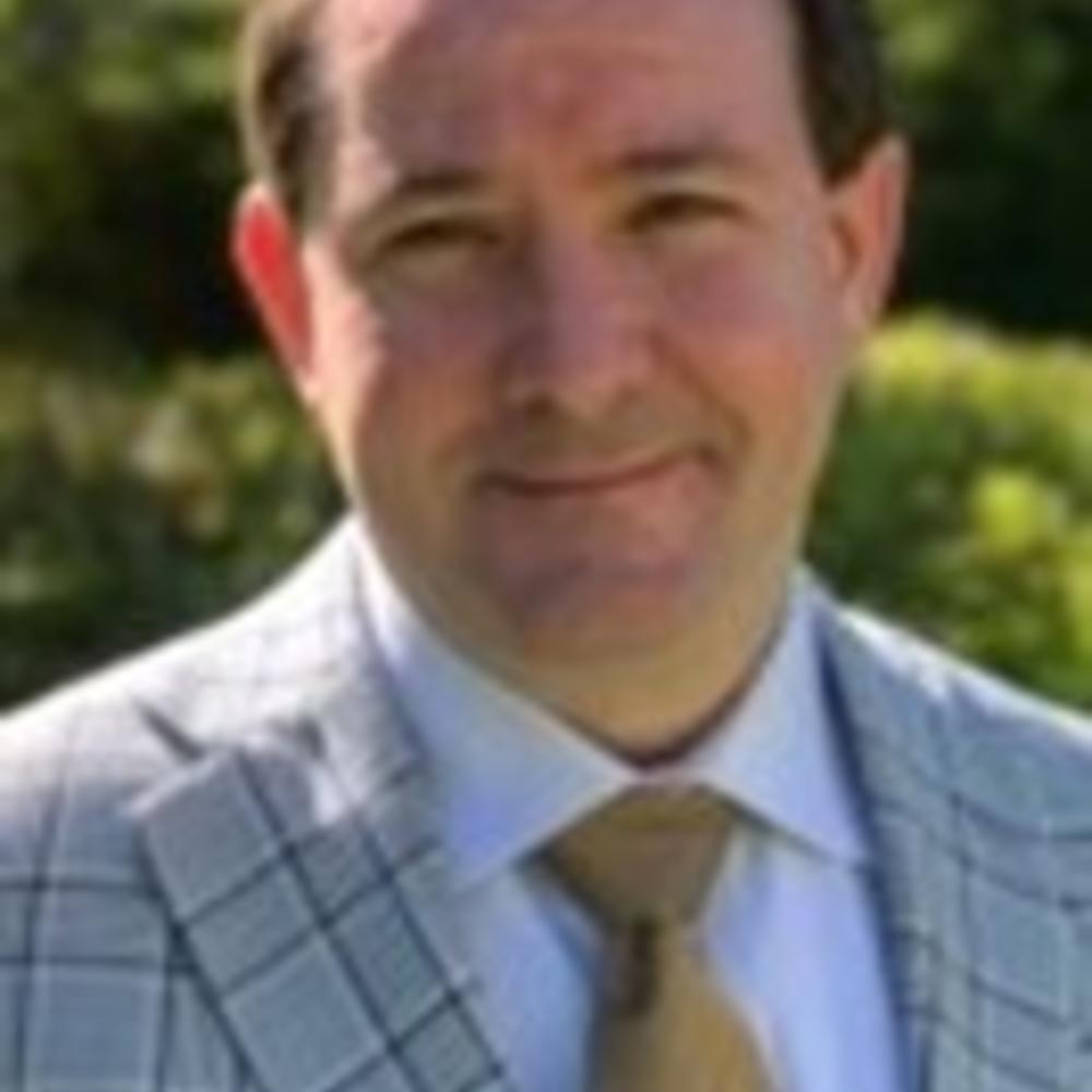 Headshot of Clark Rainer in suit and tie