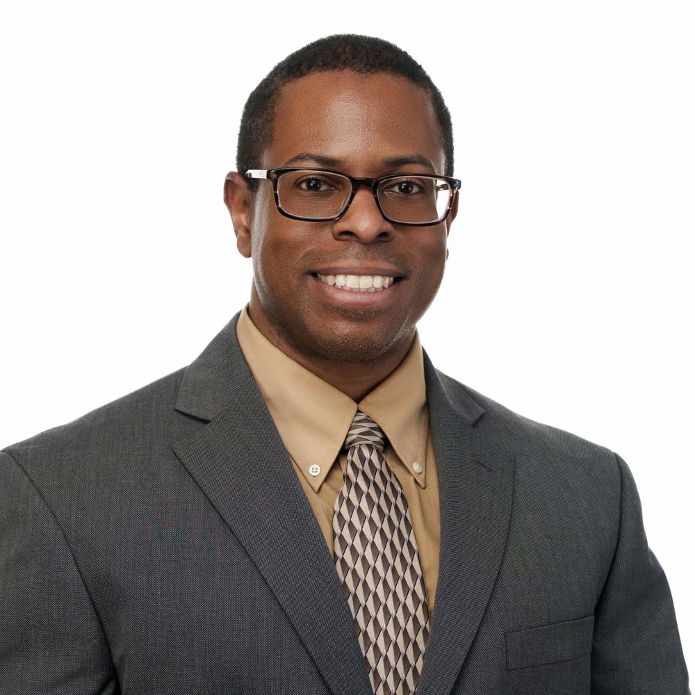 Head and shoulder shot of Robert Palmer in suit and glasses