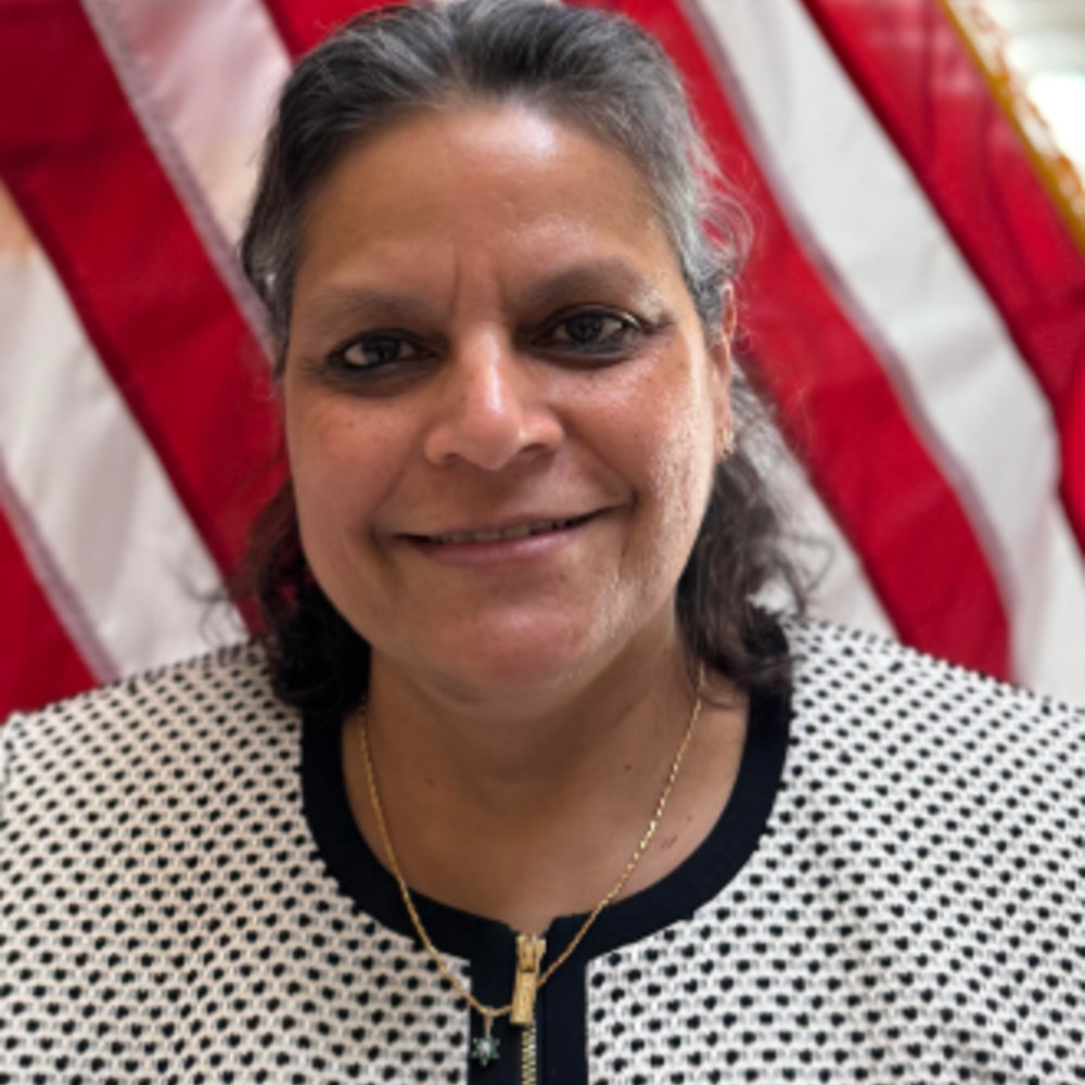 Head and shoulder shot of Jaya Krishnan woman with short brown hair wearing a jacket